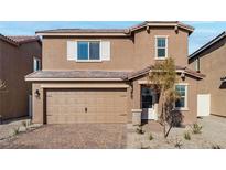 Charming two-story home featuring a brick driveway, two-car garage, and well-maintained landscaping at 4223 Gold Desert St, North Las Vegas, NV 89032