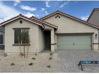 Charming single-story home features a well-manicured front yard and a neutral color palette at 4416 Cave Lake Ave, North Las Vegas, NV 89032