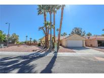 Charming single-story home features a two-car garage, desert landscaping, and swaying palm trees at 4416 Inez Dr, Las Vegas, NV 89130