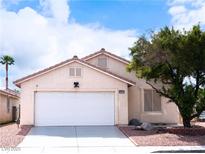 Charming single-story home featuring a two-car garage and desert landscaping under a sunny sky at 5541 Alvarez St, North Las Vegas, NV 89031