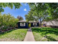 Charming single-story home with a well-manicured lawn and mature trees at 604 I, Boulder City, NV 89005