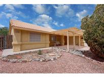 Charming single-story home with a covered patio and desert landscaping at 6460 Wagon Wheel Ct, Pahrump, NV 89061