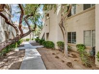 Charming condo exterior featuring lush greenery, mature trees and a well-maintained landscape at 6480 Annie Oakley Dr # 314, Las Vegas, NV 89120