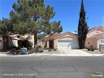Charming single-story home featuring desert landscaping, a two-car garage and a terra cotta tiled roof at 6512 Sterling Springs Pkwy, Las Vegas, NV 89108