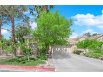 Charming single-story home featuring a neutral color palette, mature trees, and a two-car garage at 6631 Creeping Thyme St, Las Vegas, NV 89148