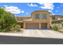 Two-story home featuring a three-car garage, neutral stucco, decorative shutters, and manicured landscaping at 6713 Guidestar St, North Las Vegas, NV 89084