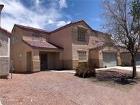 Charming home with a red tile roof, two-car garage and desert landscaping at 6726 Montezuma Castle Ln, North Las Vegas, NV 89084