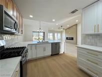 Modern kitchen features stainless appliances, white cabinets, and an open concept design at 9369 Villa Ridge Dr, Las Vegas, NV 89134