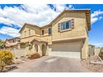 Tan two-story home with attached garage and desert landscaping at 978 Valetta Flat Ave, Las Vegas, NV 89183