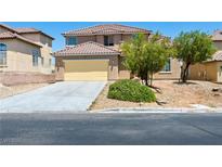 Inviting two-story home featuring a yellow two-car garage and well-maintained landscaping at 16 Goldleaf Falls Ave, North Las Vegas, NV 89031