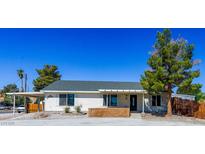 Charming single-story home with a spacious front yard and a covered carport at 208 W Alma St, Overton, NV 89040