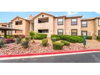 View of the apartment exterior featuring well-maintained landscaping with rocks and green shrubs at 2451 N Rainbow Blvd # 2131, Las Vegas, NV 89108