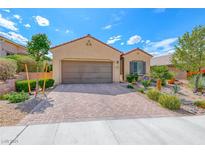 Charming single-story home featuring a well-manicured front yard and a two-car garage at 2601 Bechamel Pl, Henderson, NV 89044