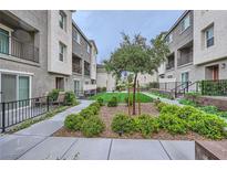 Beautifully landscaped community courtyard with walkways and manicured green spaces at 2845 Copper Wind Ln # 4, Las Vegas, NV 89183