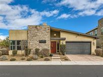 Beautiful single-story home featuring stone accents, desert landscaping, and a two-car garage at 3008 Barrett Springs Ave, Henderson, NV 89044