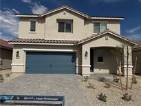 Two-story home featuring a blue garage door, desert landscaping, and a covered front porch at 4405 Pioche Ave, North Las Vegas, NV 89032