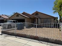 Charming single-story home featuring a front yard with metal fencing at 4923 Arizona Ave, Las Vegas, NV 89104