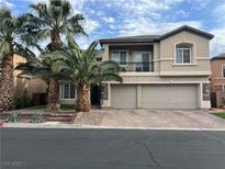 Two-story home with a three car garage, manicured landscaping, and mature palm trees at 7109 Rancho De Taos, Las Vegas, NV 89130