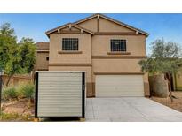 Two-story home with a two-car garage and neutral paint scheme, plus a portable storage container on the driveway at 9017 Wolf Dancer Ave, Las Vegas, NV 89143