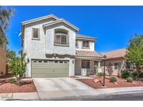 Charming two-story home featuring a well-manicured front yard and attached two-car garage, offering curb appeal at 11143 Castellane Dr, Las Vegas, NV 89141