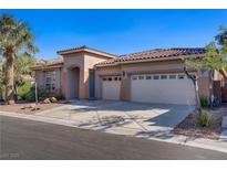 Charming single story home featuring desert landscaping and a three car garage at 11369 Rancho Villa Verde Pl, Las Vegas, NV 89138