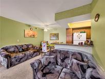 Cozy living room featuring plush sofas, a dining area, and a kitchen with modern appliances at 1455 E Katie Ave # K14, Las Vegas, NV 89119