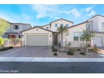 Charming two-story home featuring a brick driveway, a two-car garage, and desert landscaping at 19 Cresta Villa Ct, Henderson, NV 89011