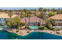 A beautiful backyard featuring a private pool with lush landscaping and waterfront views at 2209 Glenbrook Way, Las Vegas, NV 89117