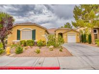 Charming single-story home showcasing desert landscaping and attached two-car garage at 2383 Rainswept Ave, Henderson, NV 89052