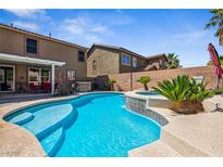 Inviting backyard pool and spa with lush landscaping and covered patio area, perfect for outdoor entertaining at 248 Hyssop Ct, Henderson, NV 89015