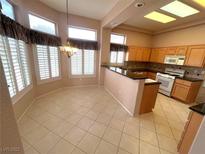 Bright kitchen and eating area with tile floor, ample windows, and plenty of natural light at 2925 Big Green Ln, Las Vegas, NV 89134