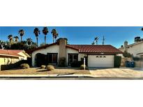 Charming single-story home featuring a Spanish tile roof, landscaped front yard, and a two-car garage at 3729 La Junta Dr, Las Vegas, NV 89120