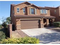Two-story home with a two-car garage and a low maintenance landscaped front yard at 4361 Duck Harbor Ave, North Las Vegas, NV 89031