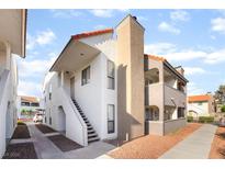 Exterior angle shot of condo building with two-story apartments and red tile roof at 611 Bass Dr # C, Henderson, NV 89014