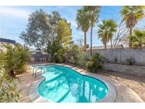 A refreshing pool with lush landscaping provides a private backyard oasis at 6223 Foothill Blvd, Las Vegas, NV 89118
