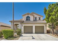 Inviting two-story home with a tile roof, lush landscaping, and a two-car garage at 841 Colina Alta Pl, Las Vegas, NV 89138