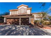 Inviting two-story home featuring a three-car garage and a well-maintained front yard at 884 E Robindale Rd, Las Vegas, NV 89123