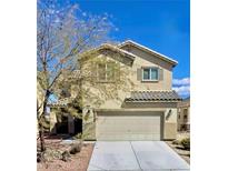 Charming two-story home featuring desert landscaping, a two-car garage, and neutral stucco facade at 948 Crescent Falls St, Henderson, NV 89011