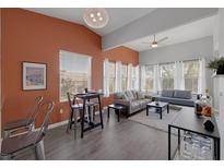 Bright living room features high ceilings, a modern ceiling fan and large windows dressed with white curtains at 10001 Peace Way # 2351, Las Vegas, NV 89147