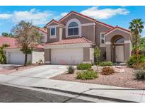 Charming two-story home featuring a red tile roof and well-maintained landscaping at 124 Wynntry Dr, Henderson, NV 89074
