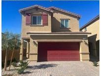 Two-story home showcasing a two-car garage, well-kept landscaping and desert plants at 1433 Gable Falls Pl # 95, North Las Vegas, NV 89084