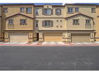 Charming townhouse with tan exterior, brown trim, and attached garages, ideal for modern living at 1525 Spiced Wine Ave # 19103, Henderson, NV 89074