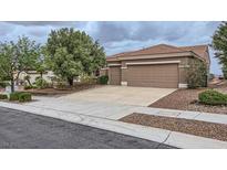 Charming single-story home showcasing a three-car garage, a well-maintained lawn, and a neutral color palette at 2110 King Mesa Dr, Henderson, NV 89012
