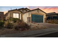Charming single-story home featuring a two-car garage, stone accents, and desert landscaping at 2128 Delmar Farms Ct, Laughlin, NV 89029