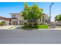 Beautiful two-story home featuring a three-car garage, manicured landscaping, and a well-maintained lawn at 220 Villa Borghese St, Las Vegas, NV 89138