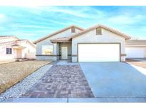 Charming single-story home with a well-manicured lawn, a two-car garage, and a welcoming entrance at 2421 Sunrise Springs Ct, North Las Vegas, NV 89031