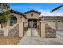 Charming single-story home with gated entry, well-manicured landscaping, and a two-car garage at 2939 Crown Bluffs Ct, Las Vegas, NV 89117