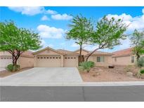 Charming single-story home featuring a three-car garage and desert landscaping at 4029 Ricebird Way, North Las Vegas, NV 89084
