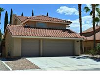 Two story home featuring a terracotta-tiled roof and a two-car garage at 4732 Illustrious St, Las Vegas, NV 89147