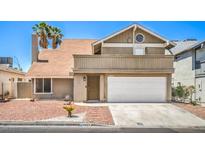 Charming home featuring a two-car garage, desert landscaping, and a classic facade at 4889 W Montara Cir, Las Vegas, NV 89121